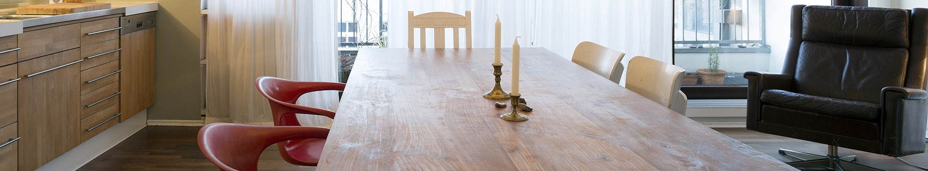 Wooden table with 2 candles on top of it